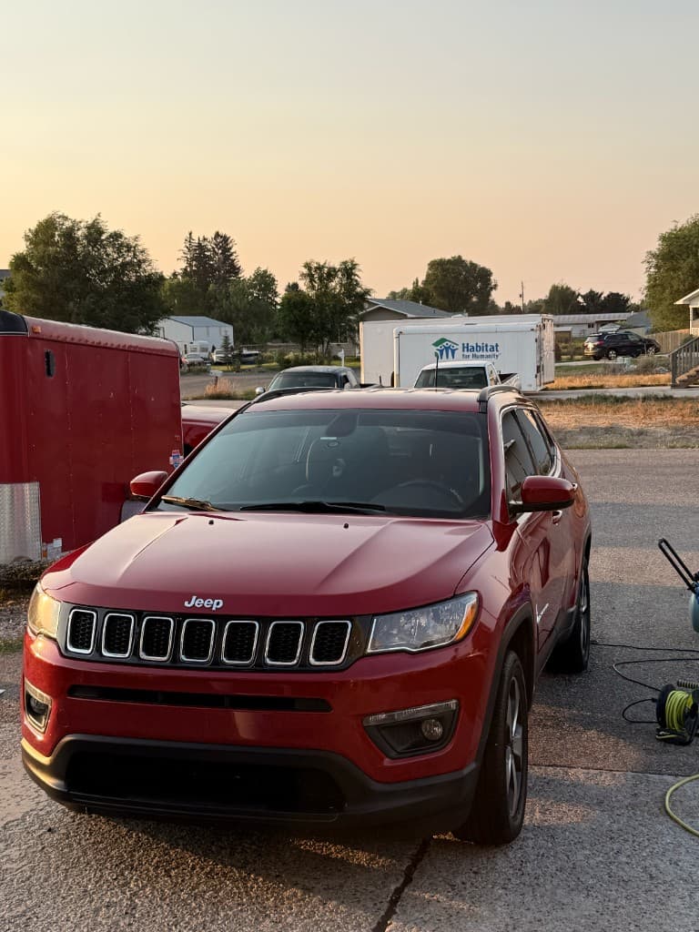 Red Jeep Compass fully detailed at sunset