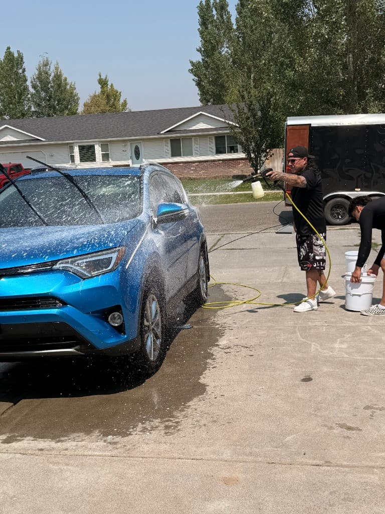 Foam Bros crew foam cannoning a blue Toyota RAV4